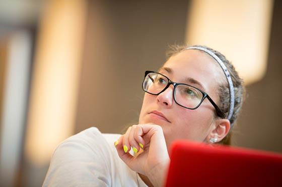 Photo of a Chatham University female student paying attention to a lecture.